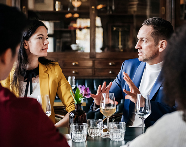 business man and business woman discuss businesses during a networking event