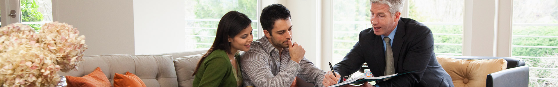 Adviser speaking to a couple in their lounge