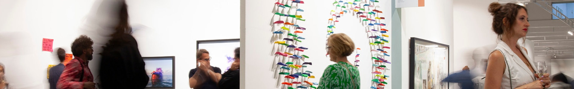 Image of people looking at art in a gallery