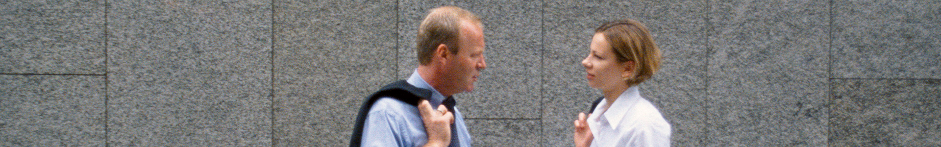 two people talking outside the london stock exchange