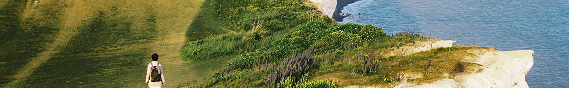 Lady walking along a cliff top