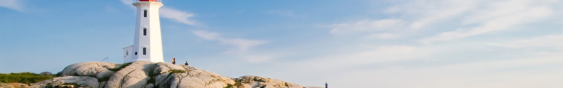 Lighthouse by cliff face near beach