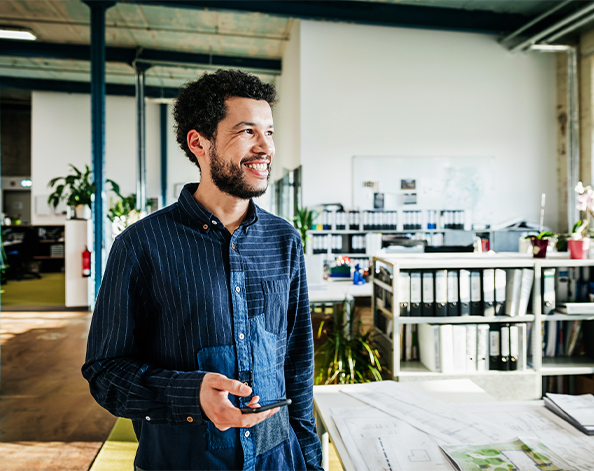 person checking finances on phone in work place