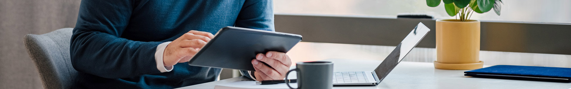 A man calculates tax on an iPad