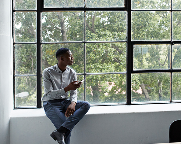 man contemplating by a window