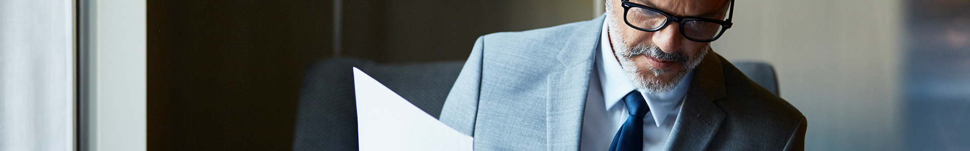 Business man looking through paperwork while sitting at restaurant table