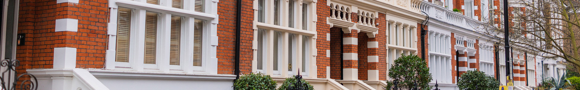 Entrances of red bricked terraced houses