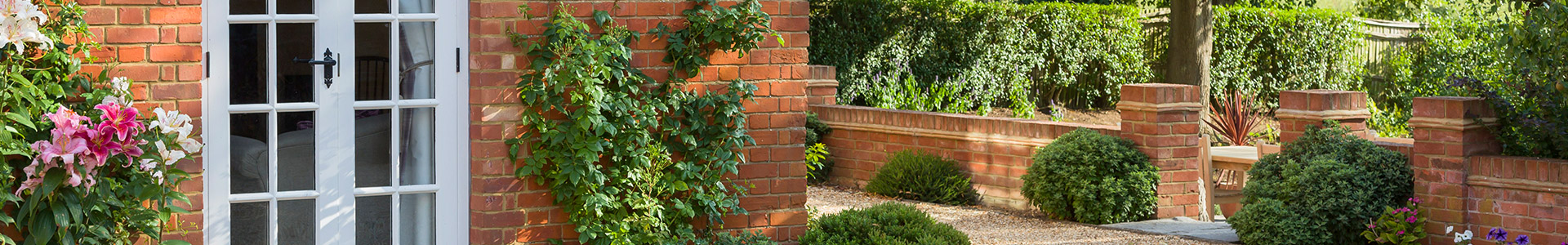 Side of a house with a country style garden