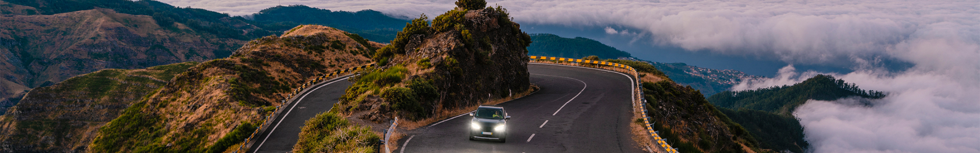 SUV driving on hairpin road in mountains