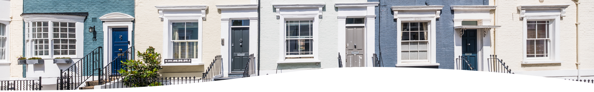 Balcony with topiary cloud tree and plants on a white terraced house in London