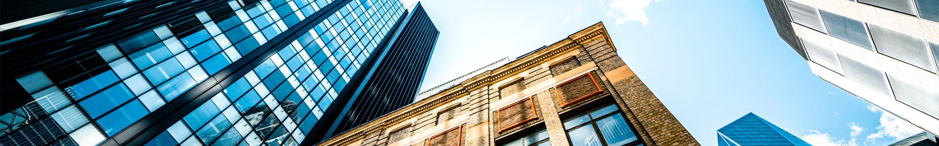 Looking up at multiple tower buildings