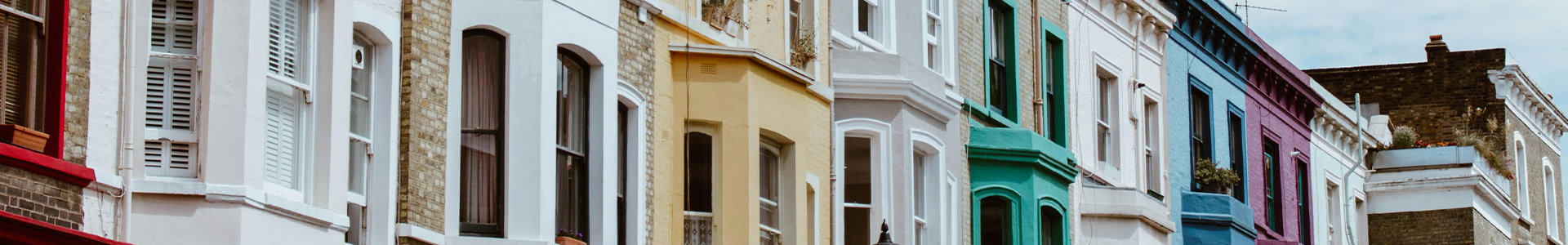 Close-up of front of row of coloured terraced houses