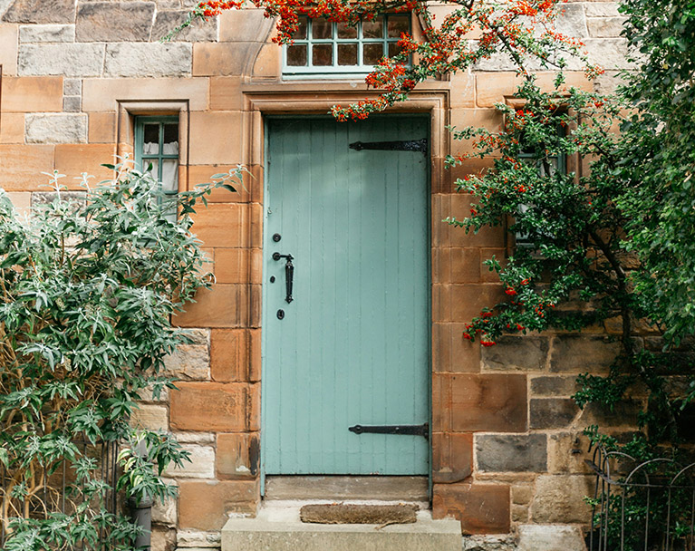 Close-up of green door on countryside house