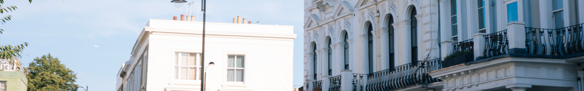 Close up of an old style terraced building with another building in the background