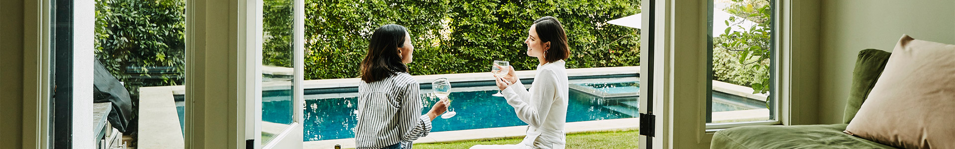 Two females enjoying a drink outside in their garden