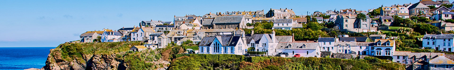 View of houses sitting on top of cliff overlooking the sea