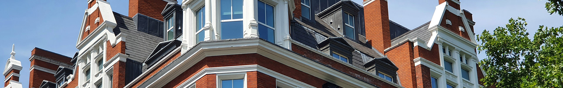 Close up of top section of old corner town house