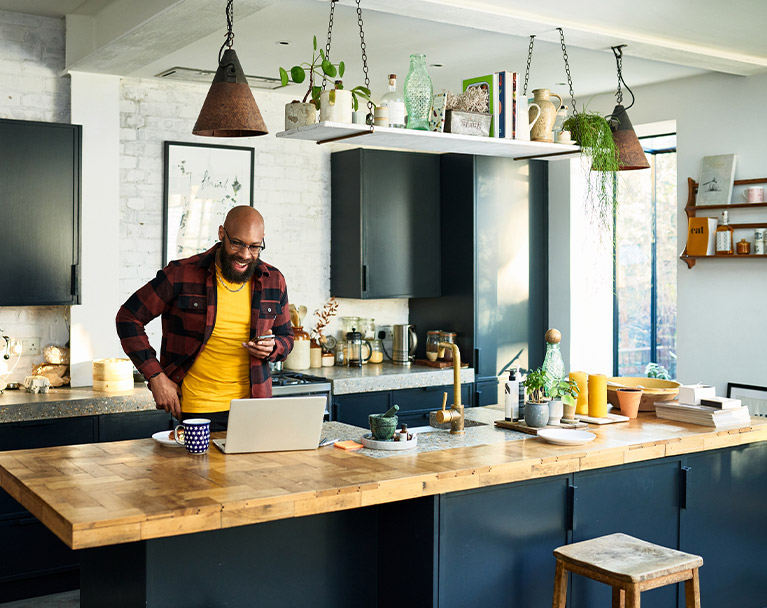 Male in his moden kitchen on an online call