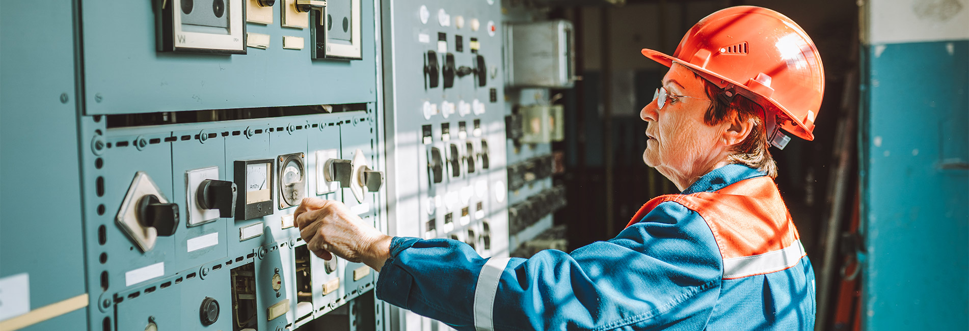 Worker checking readings on the electricity machines