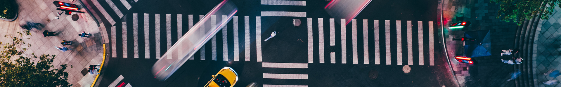 Cross roads in the middle of a busy city centre from above