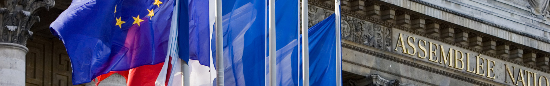 EU flag and French flags flying outside building