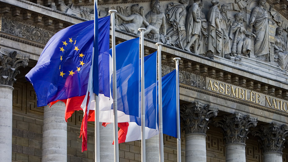 EU flag and French flags flying outside building