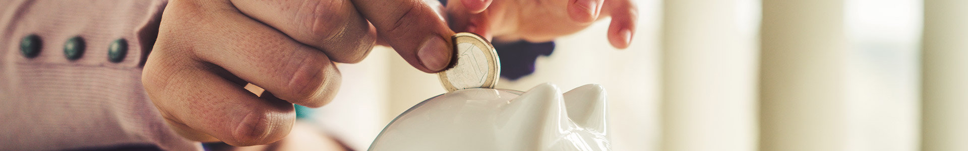 Parent and child putting coin in money box