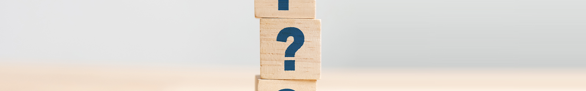 Wooden blocks with question marks on them