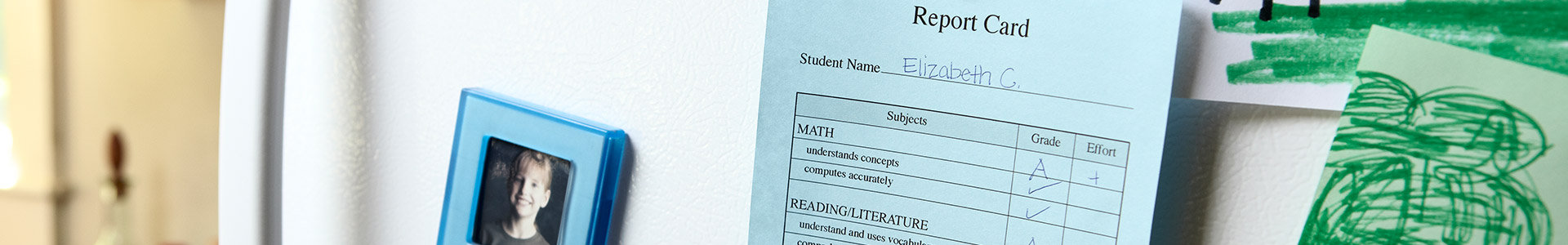 Report card hanging on fridge