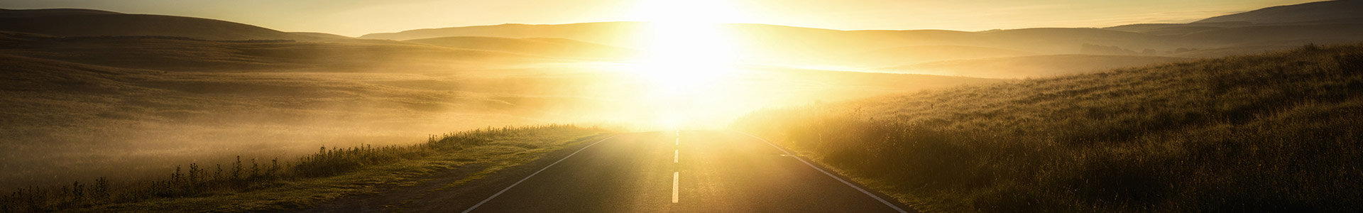 Sunlight reflecting from the mist on a road