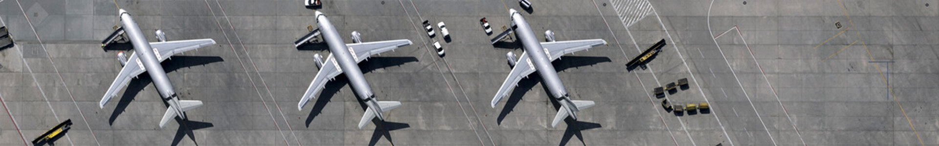 Three planes sitting on airport runway