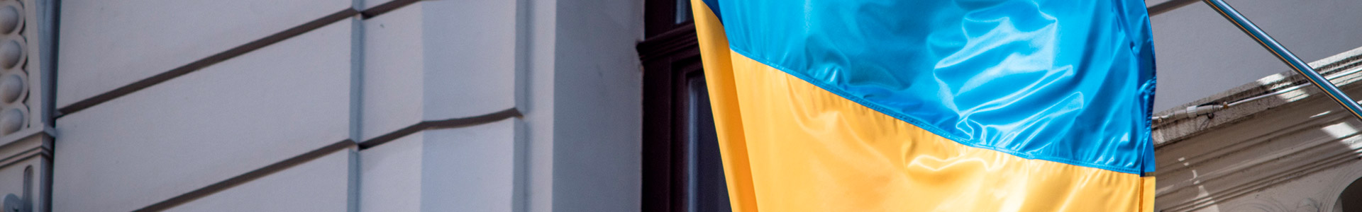 Ukraine flag hanging outside a building