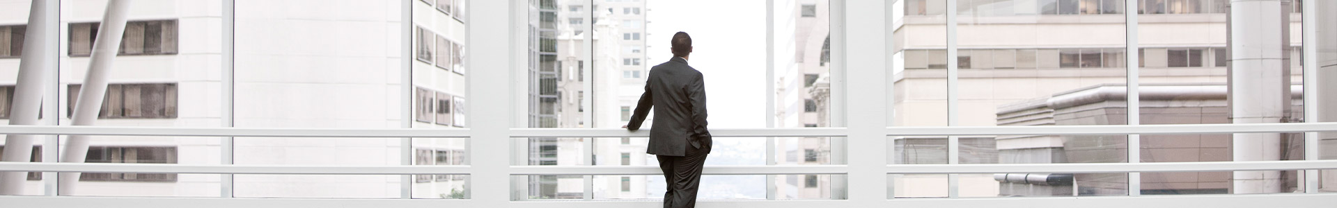 Male staring at building architecture