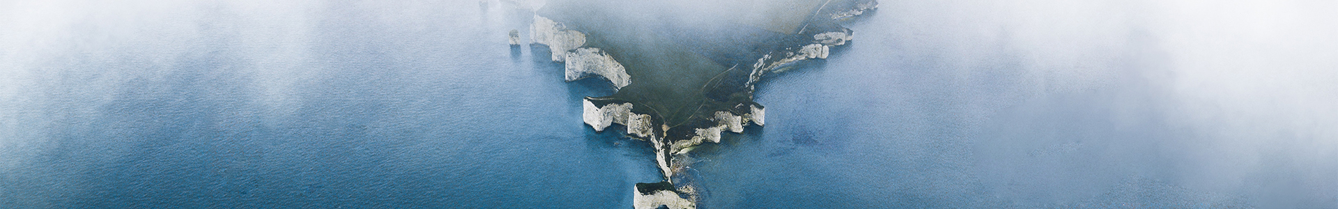 View of coastline from above with mist around