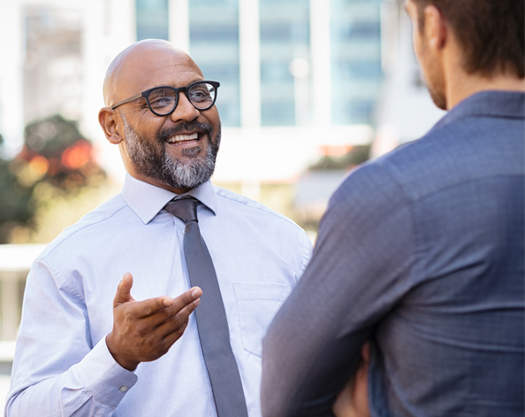 An IFA talks with their client during a conversation in a garden