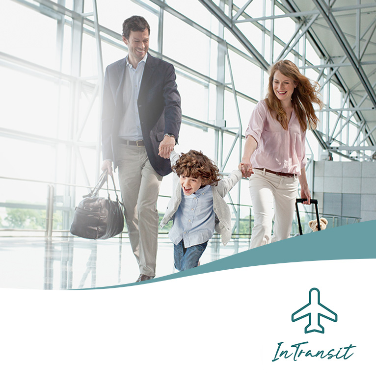 Family walking through airport with their bags