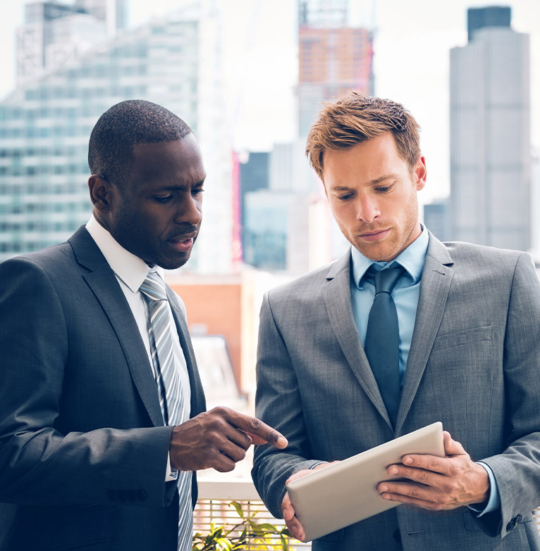 Two businessmen looking at a tablet