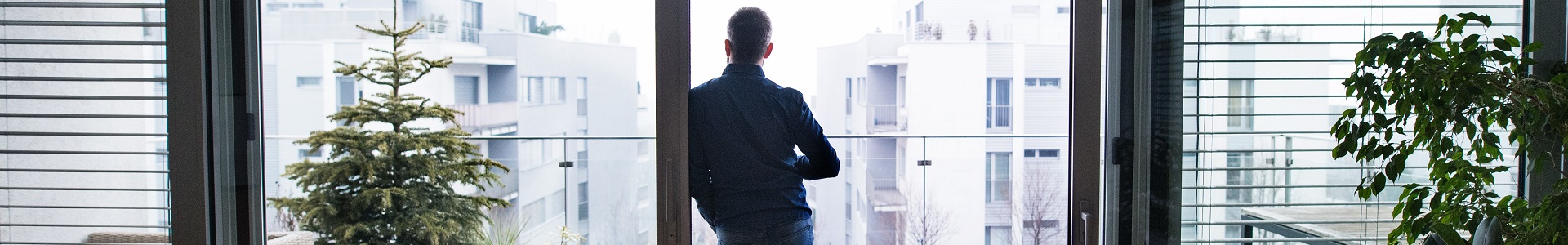 A man looking out at the view from his new property, secured with a buyers agent.