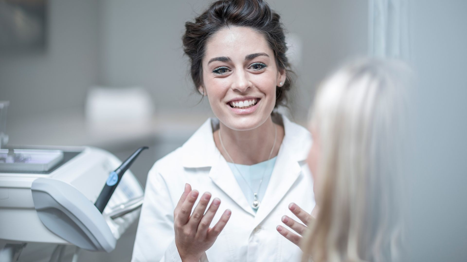 Dentist talking to her client