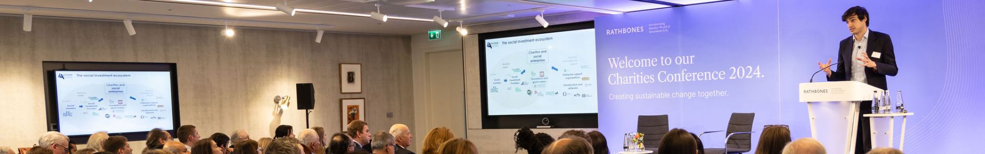 A packed room of attendees listen to Seb Elsworth at the Charities Conference by Investec Wealth & Investment