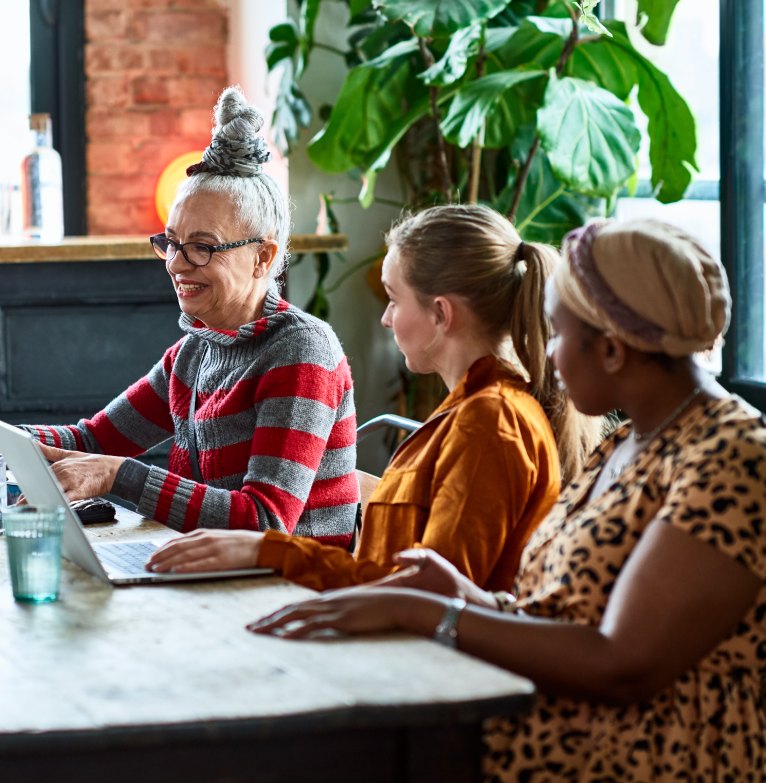 Three charity workers discuss ideas during a training session