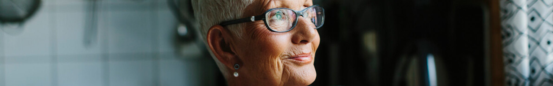 Older woman looking out of the window