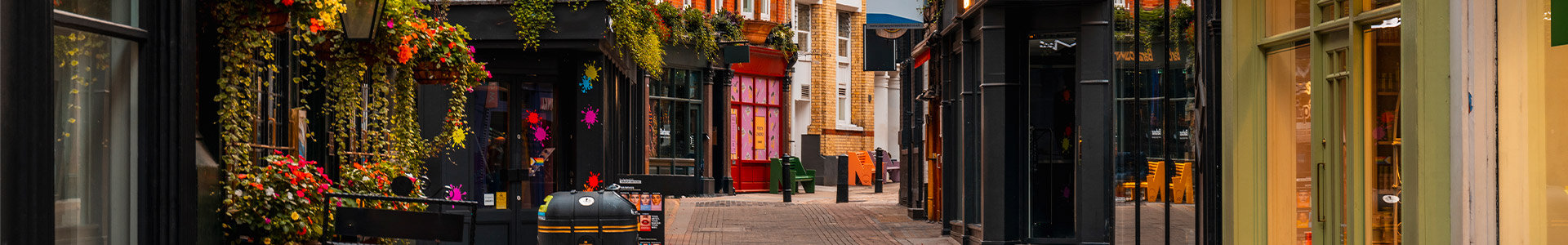 Backing British businesses with investment capital - showing a side street in London with shops and pubs either side