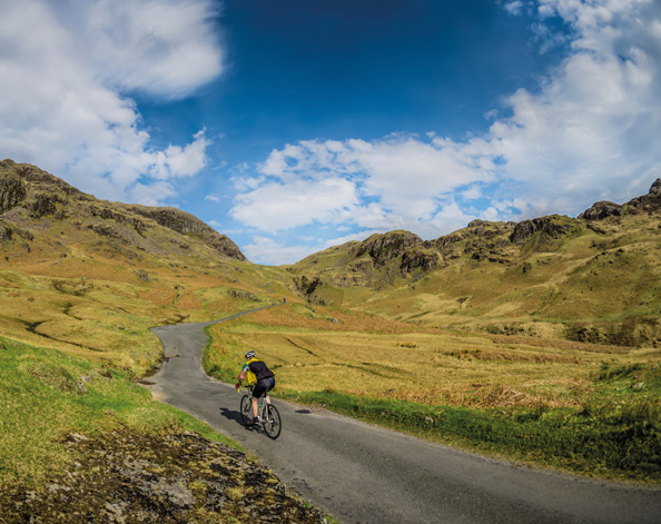 Person cycling up a hill