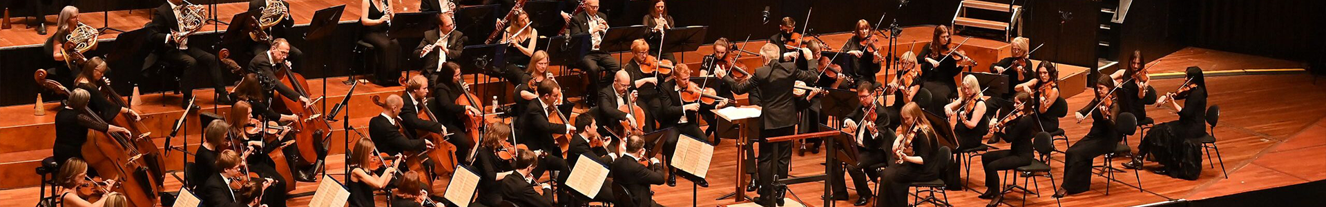 The Bournemouth Symphony Orchestra performs on stage