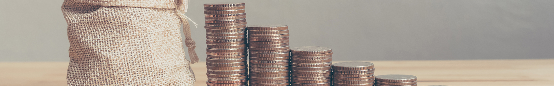 Stacks of pennies and saved pennies in a sack
