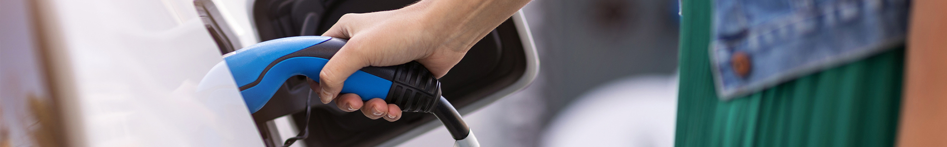 Woman charging of an electric car