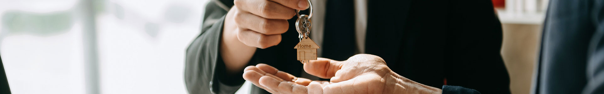 Estate agent handing over keys to a new home owner