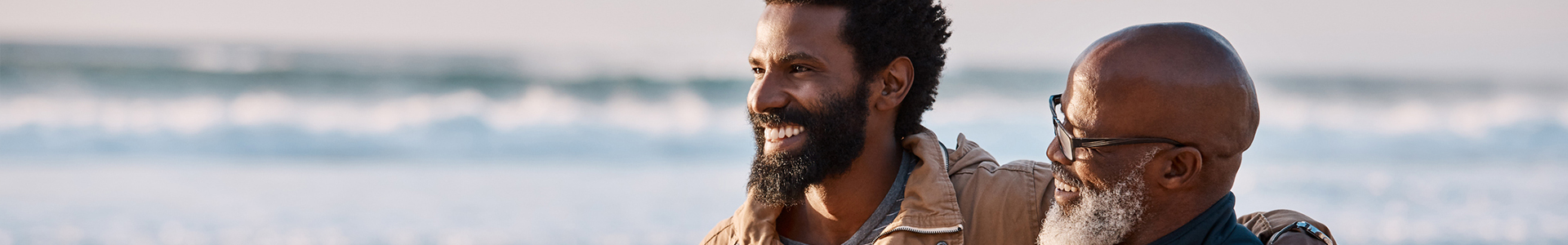 Shot of a young man going for a walk along the beach with his father