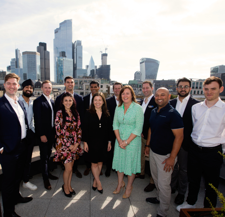 Some of the staff at Investec Wealth & Investment's London office stand on our balcony in the sunshine